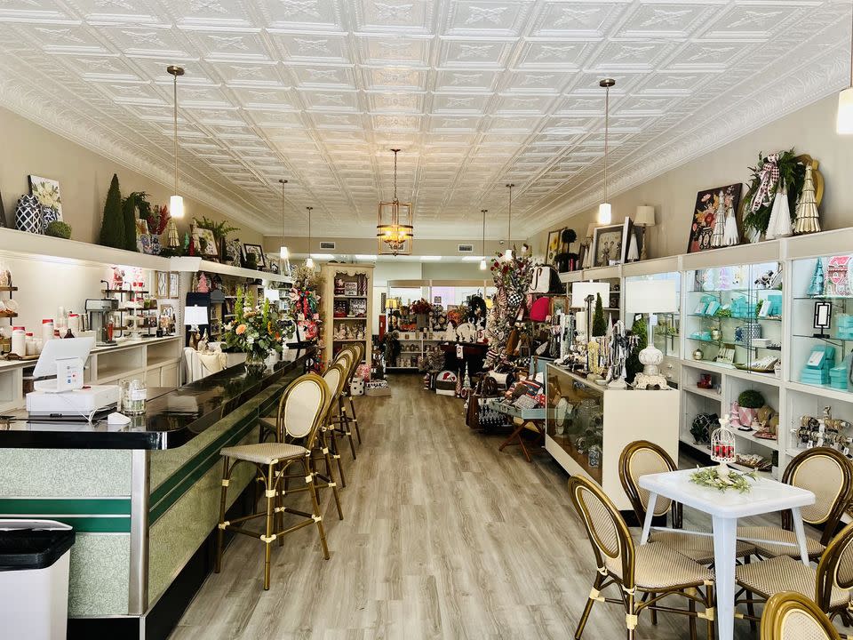 The interior of a store with a long counter and merchandise displayed on shelves