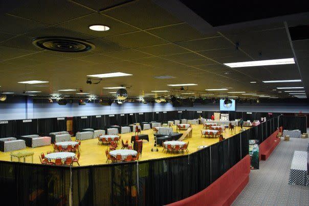Round tables with red chairs set inside a mesh enclosure