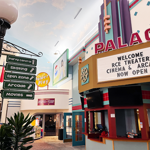 An elevated sign gives directions to different entertainment areas